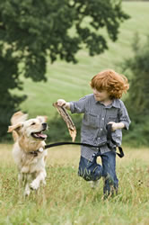 child running with dog